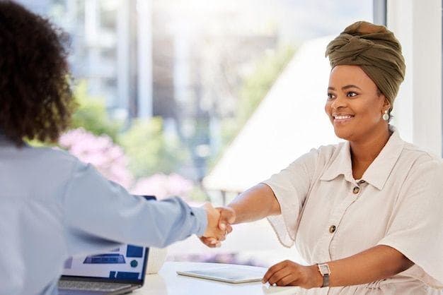 A partner greeting a client across a desk