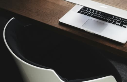 Employee working from a desk while time-off and schedule requests are managed in Wisewage